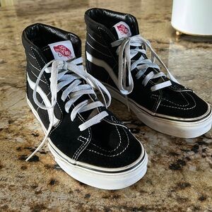 Vans black and white suede high top shoes.
